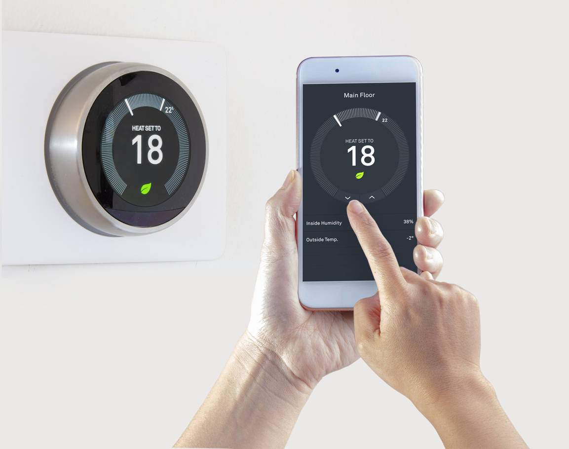 Smart thermostat being controlled on a smartphone