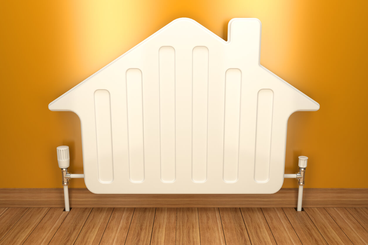 House shaped radiator against a yellow wall
