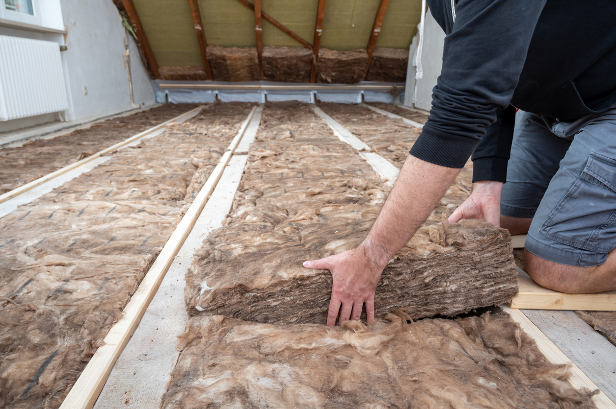 Man insulating the attic