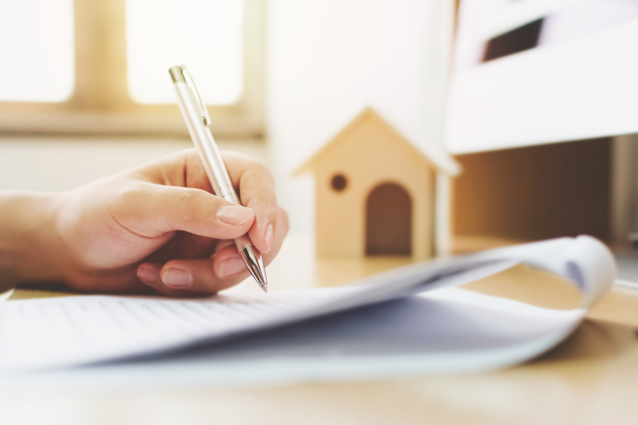 close up of hand filling out building regulation documents
